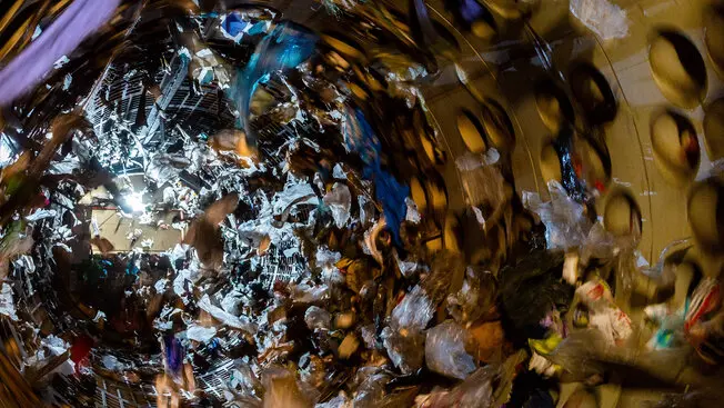 A dynamic and visually striking image of recyclable materials captured in a blurred, spinning motion.