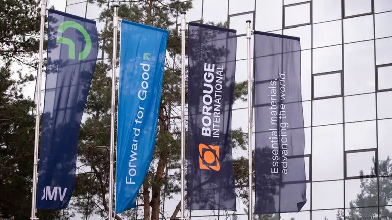 Flags of OMV and Borouge waving in the wind in front of headoffice